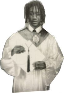 A black and white photograph of a young black man in graduation attire. This is Tyler Hart. 