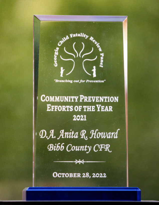 A clear acrylic award with Community Prevention Effort of the Year 2022 DA Anita R Howard Bibb County CFR